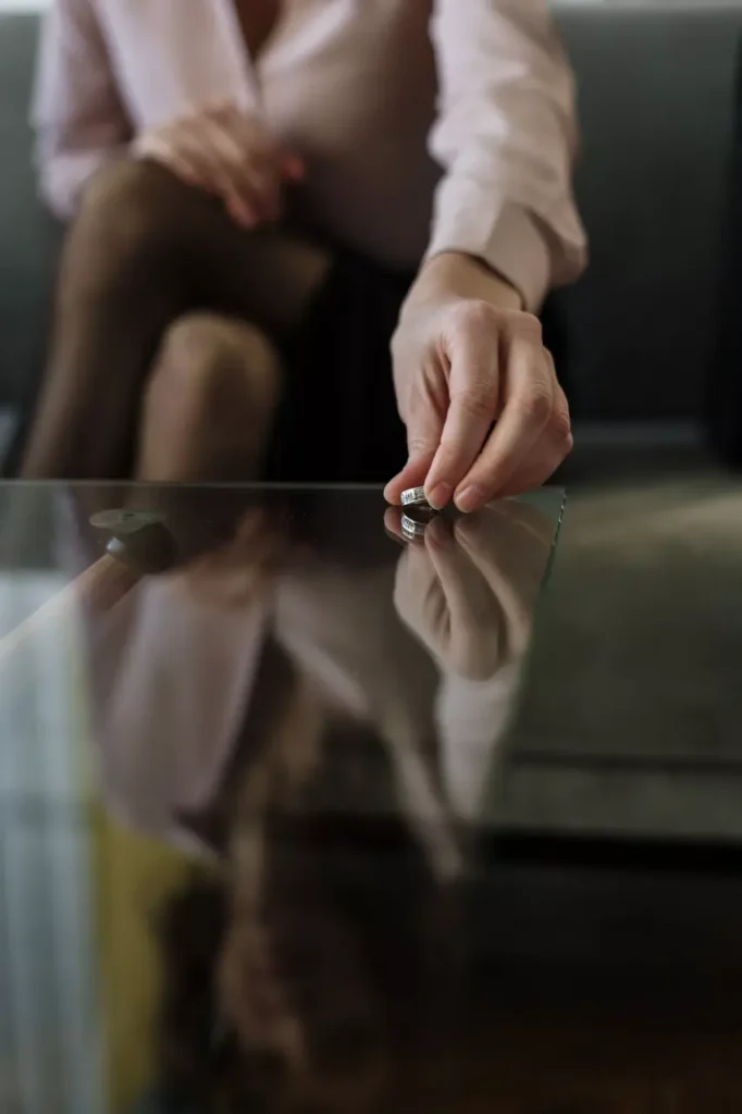 A person sitting by a window, contemplating and reflecting, representing emotional support during divorce therapy with Polaris Psychology.